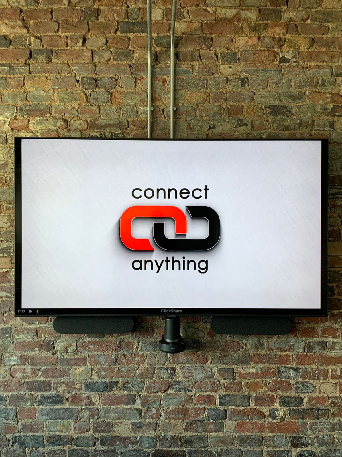 All in one conferencing solution installed on brick wall